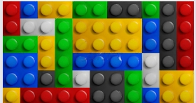 Bloques de construcción de colores que representan los elementos esenciales para estructurar una tesis académica de manera coherente y organizada.
